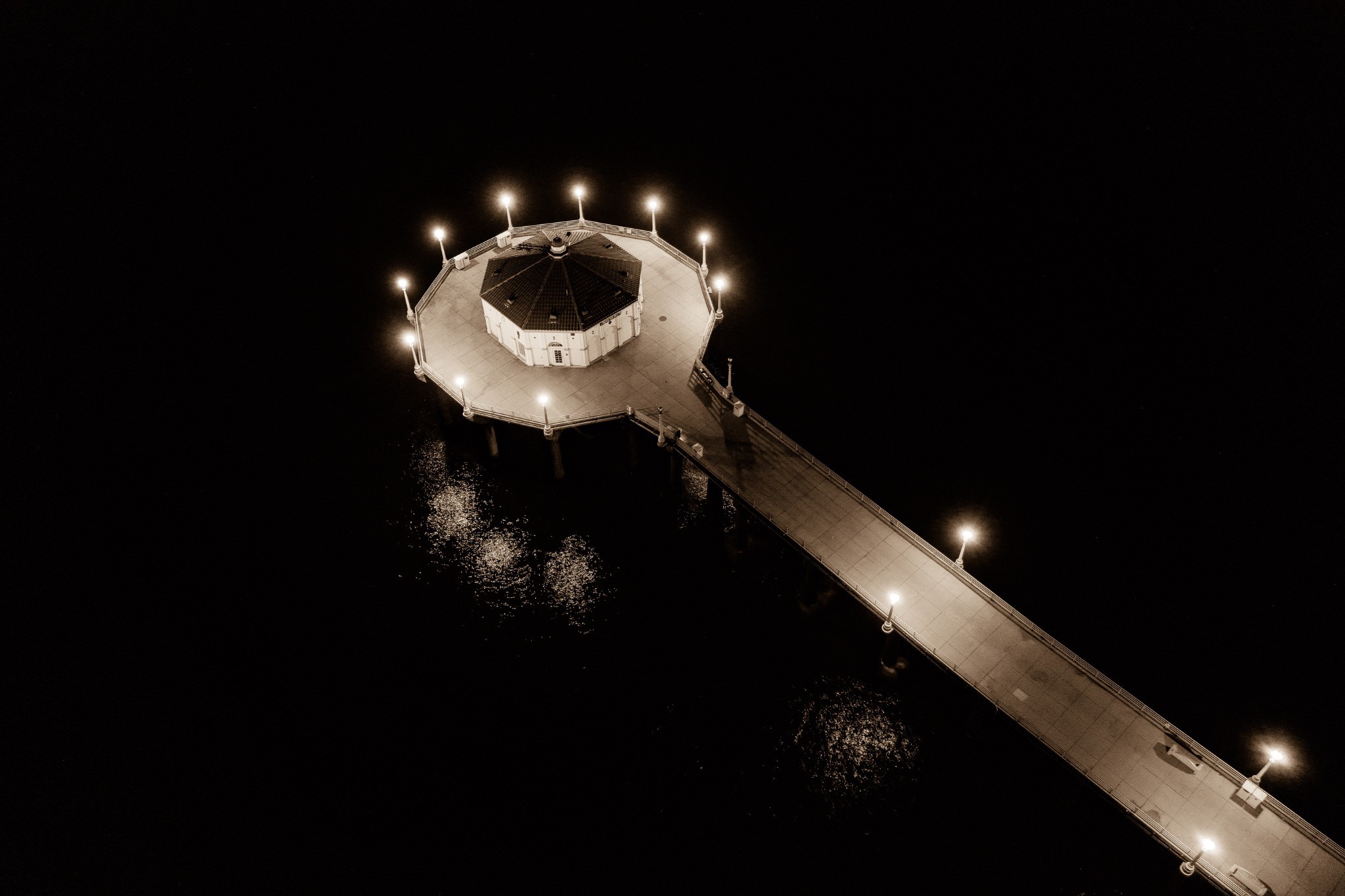 Illuminated pier at night photographed by Paul Towers